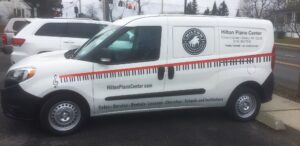White van with piano keyboard graphic